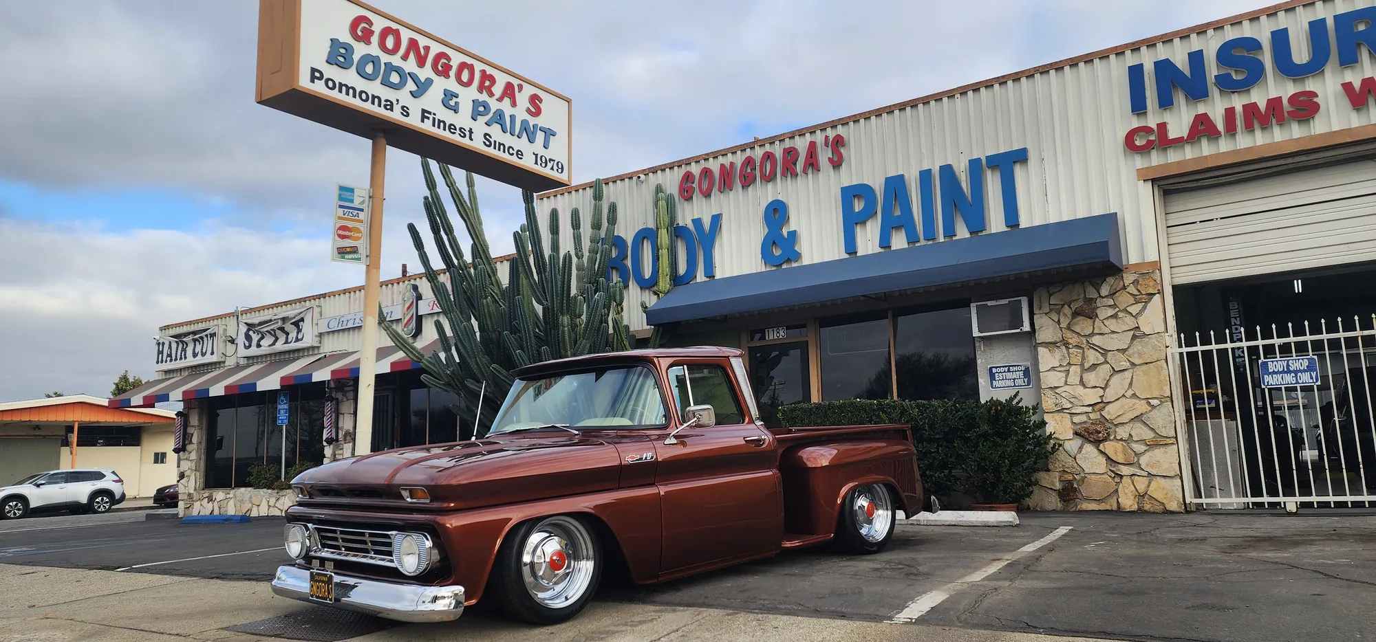 A lowered brown classic Chevy pickup parked in front of Gongora’s on Holt Avenue